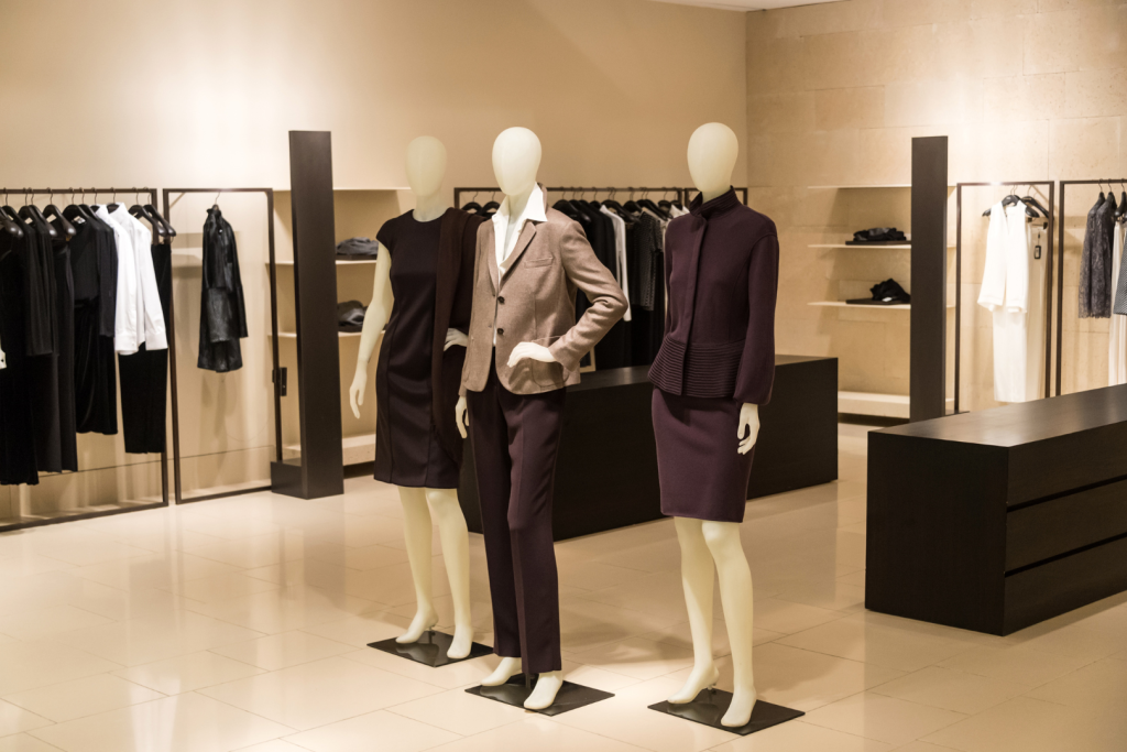 Modern apparel retail store displaying women’s garments sourced from Indian clothing manufacturers. This image shows a contemporary retail interior with mannequins dressed in coordinated women’s outfits produced by Indian clothing manufacturers, reflecting structured production, quality finishing, and readiness for global retail supply chains.