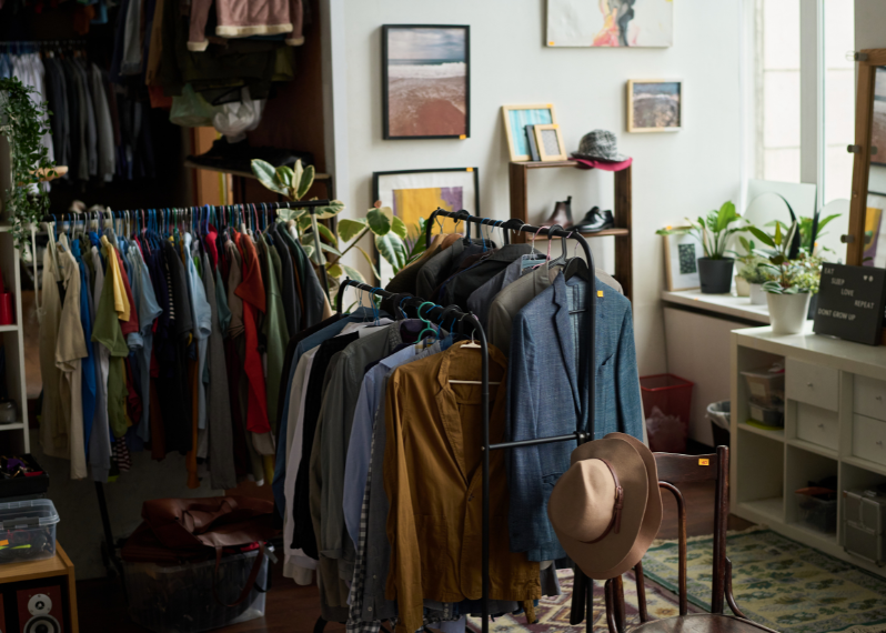 Curated Apparel & Home Textile collections displayed on clothing racks in a boutique sourced from Indian clothing manufacturers.
