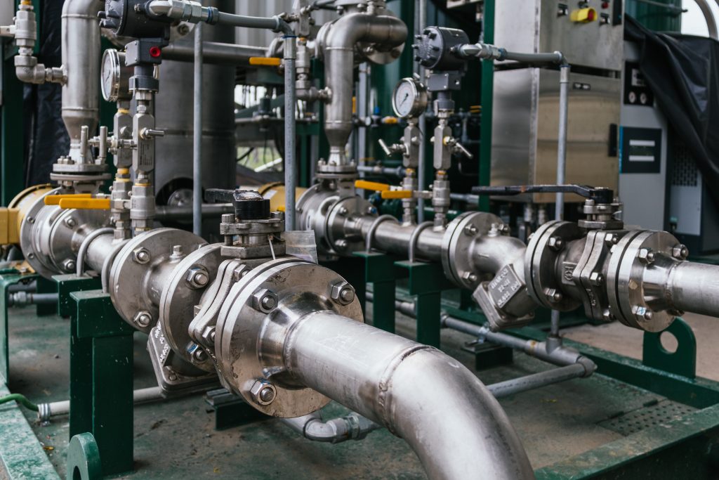 Industrial piping and valve systems monitored under supplier quality management protocols. The image highlights an industrial piping network with valves and pressure instruments, illustrating supplier quality management through system verification, maintenance oversight, and adherence to documented operational standards.