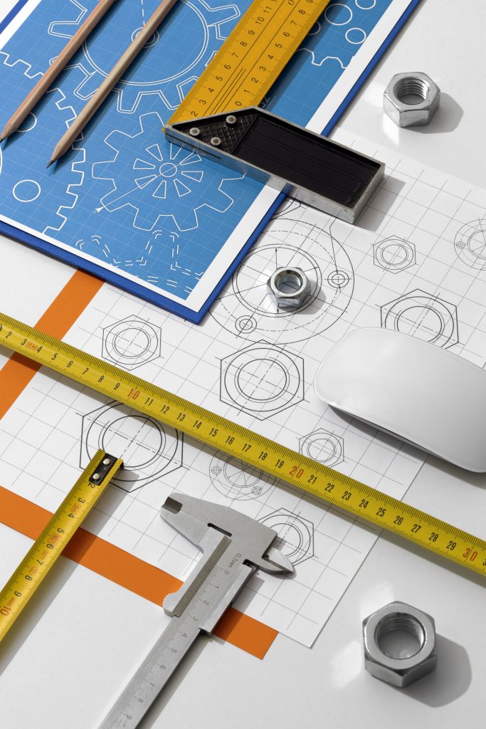 Engineering drawings and dimensional planning for casting manufacturers. The image highlights technical drawings, precision measuring tools, and component layouts used during pre-production planning. These artefacts form the foundation for clear communication with casting manufacturers, ensuring tolerances, specifications, and performance requirements are consistently translated into cast components.
